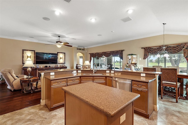 kitchen featuring dishwasher, a spacious island, and sink