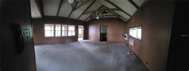 spare room featuring vaulted ceiling with beams and a wall unit AC