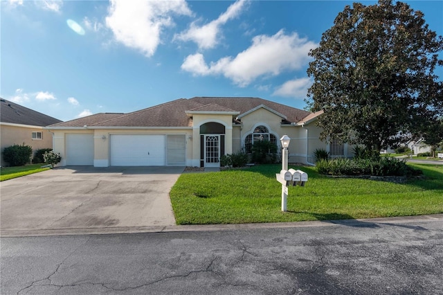 view of front of home with a front yard and a garage