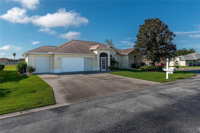 single story home featuring a garage and a front yard