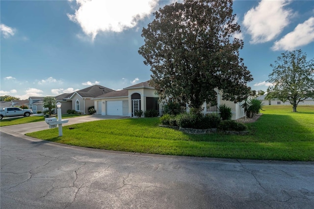 single story home featuring a front yard and a garage