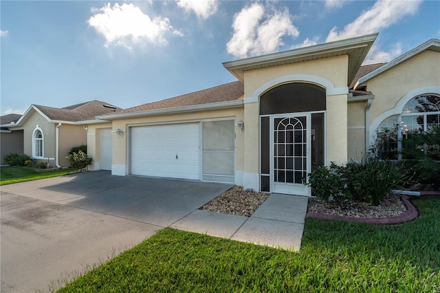 view of front of house featuring a garage and a front lawn