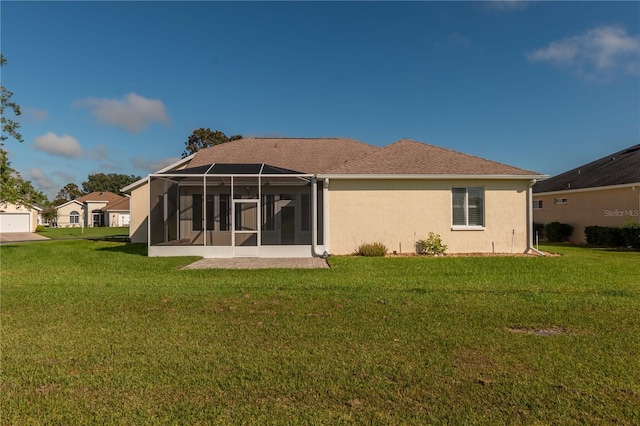 rear view of house with a sunroom and a yard