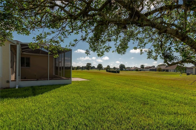 view of yard with glass enclosure