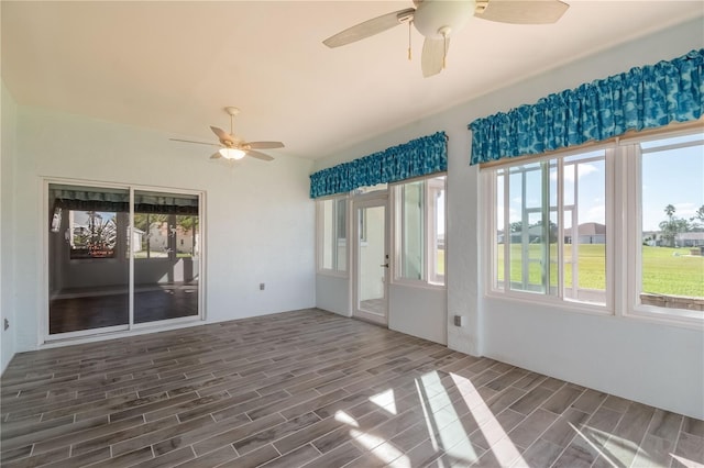 unfurnished sunroom with ceiling fan