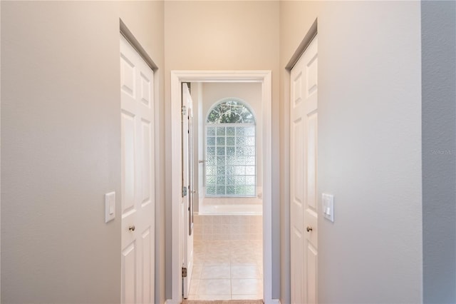 hallway featuring light tile patterned flooring