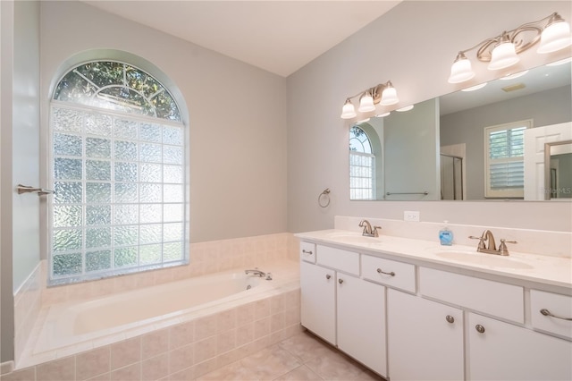 bathroom with tile patterned flooring, vanity, and separate shower and tub