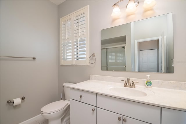 bathroom with vanity, toilet, and a shower with shower door