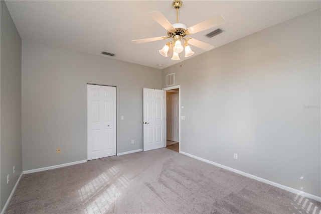 unfurnished bedroom featuring light carpet, ceiling fan, and a closet