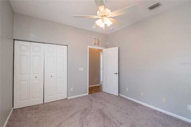 unfurnished bedroom with light carpet, ceiling fan, and a closet