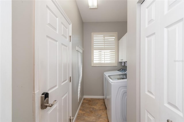 washroom with cabinets and washing machine and clothes dryer