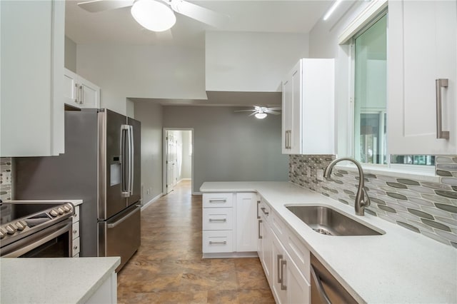 kitchen with white cabinets, stainless steel appliances, tasteful backsplash, and sink