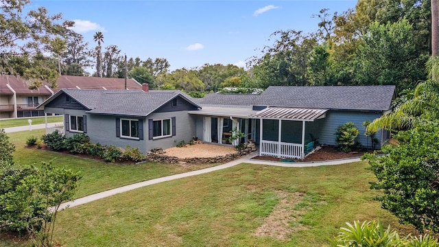 rear view of property featuring a yard