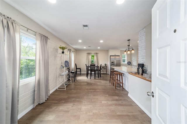 interior space featuring a chandelier and light hardwood / wood-style floors