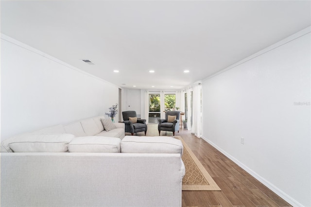 living room featuring hardwood / wood-style floors and crown molding