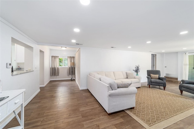 living room with crown molding and hardwood / wood-style flooring