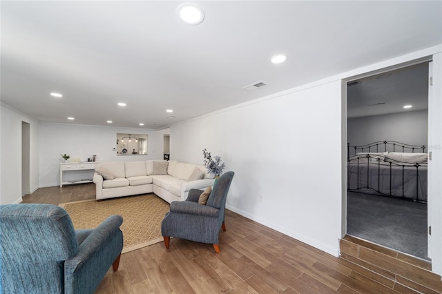 living room featuring ornamental molding and hardwood / wood-style floors