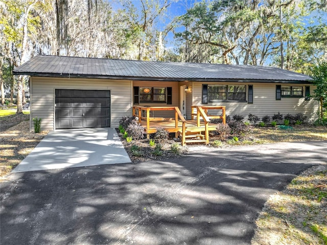 ranch-style house with a porch and a garage