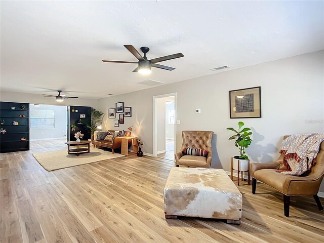 sitting room featuring light hardwood / wood-style floors and ceiling fan