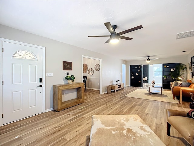 living room with hardwood / wood-style floors and ceiling fan