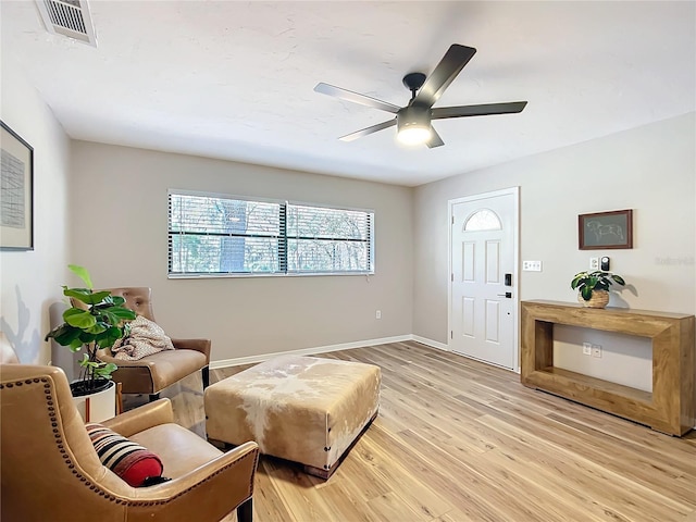 sitting room with ceiling fan and light hardwood / wood-style flooring