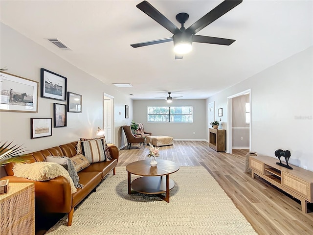 living room with light hardwood / wood-style floors and ceiling fan