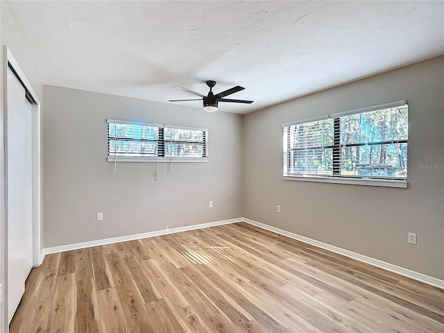 unfurnished room featuring ceiling fan and light wood-type flooring