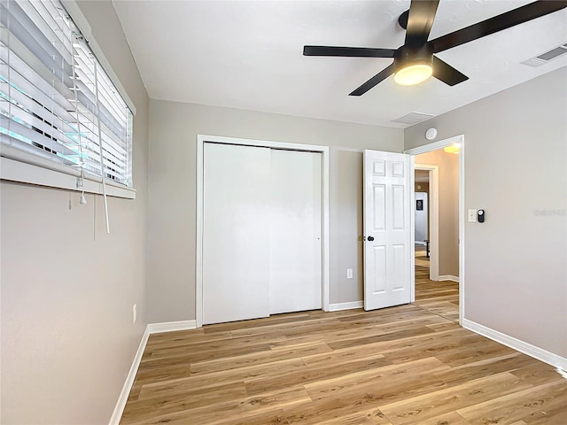 unfurnished bedroom with a closet, ceiling fan, and light hardwood / wood-style flooring