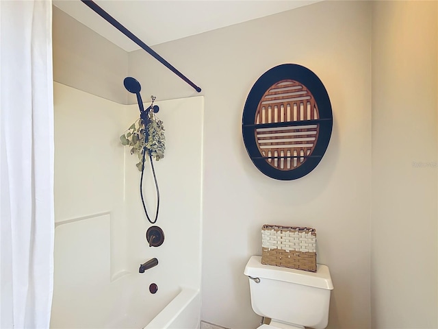 bathroom featuring washtub / shower combination and toilet