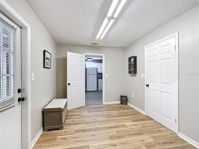 hall with light hardwood / wood-style floors