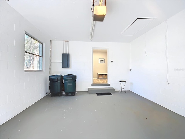 garage featuring a garage door opener and electric panel