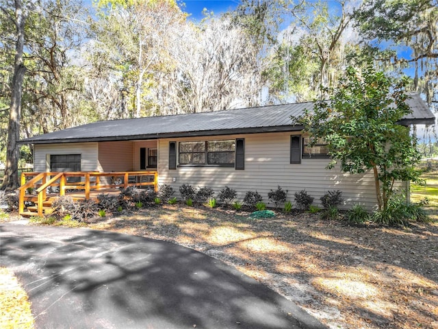 ranch-style home featuring a wooden deck