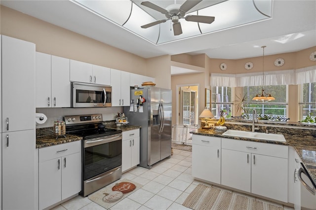 kitchen featuring white cabinets, hanging light fixtures, stainless steel appliances, and sink