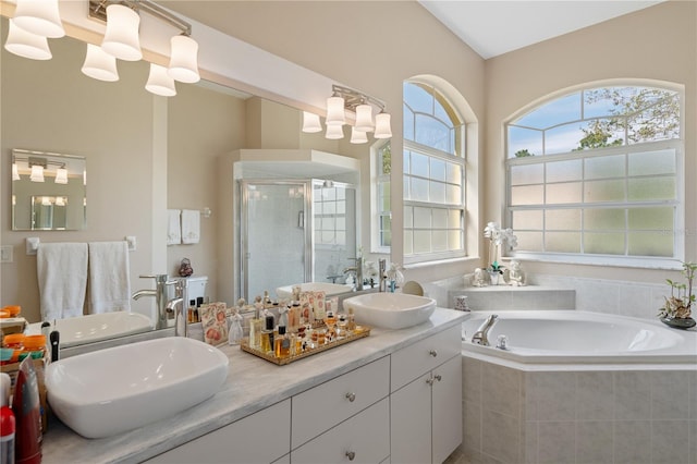 bathroom featuring vanity, an inviting chandelier, and plus walk in shower