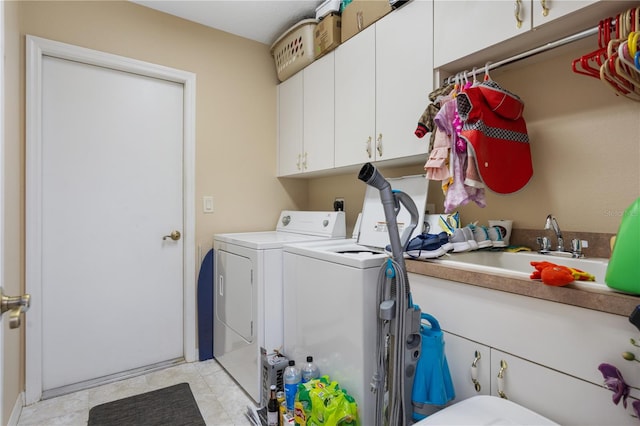 laundry room featuring independent washer and dryer, cabinets, and light tile patterned floors