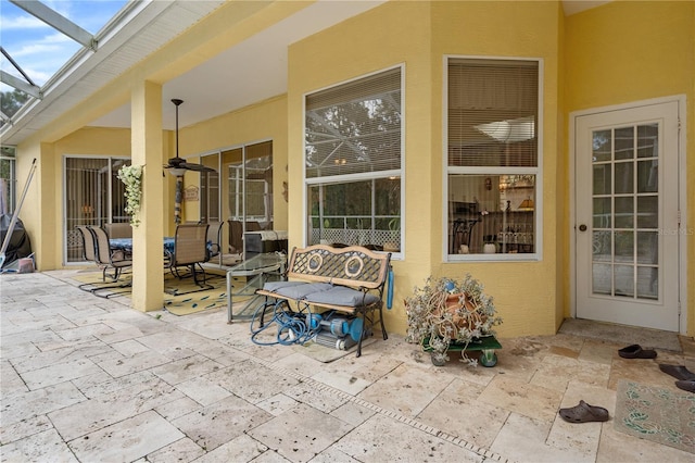 view of patio featuring a lanai