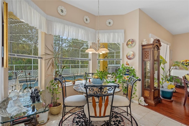 sunroom / solarium with a chandelier