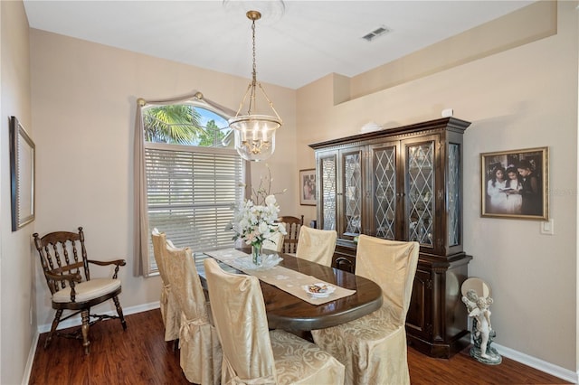 dining room with a notable chandelier and dark hardwood / wood-style floors