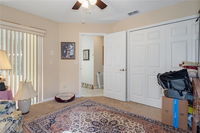 bedroom with light colored carpet, a closet, and ceiling fan