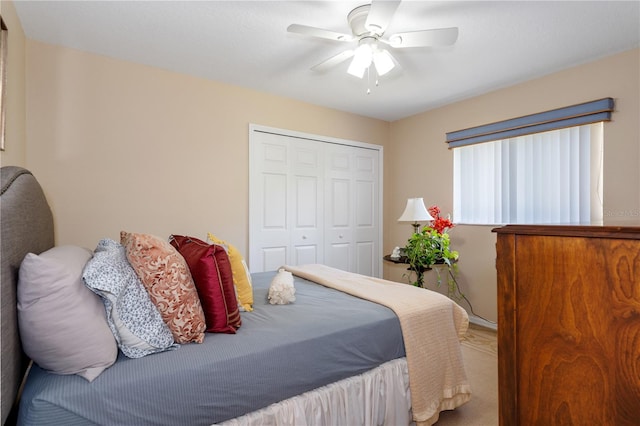 carpeted bedroom featuring a closet and ceiling fan