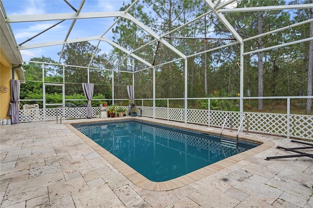 view of pool featuring a patio area and glass enclosure