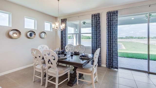 dining area with an inviting chandelier, plenty of natural light, and light tile patterned floors