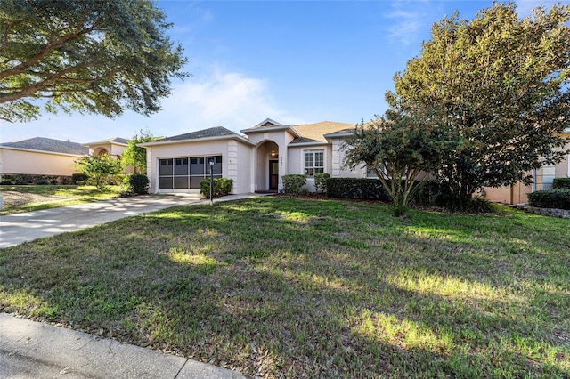 single story home featuring a garage and a front lawn