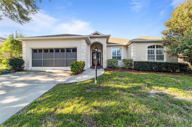 single story home featuring a front yard and a garage