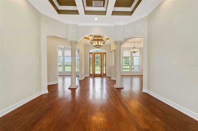 interior space with ornate columns, wood-type flooring, crown molding, a notable chandelier, and french doors