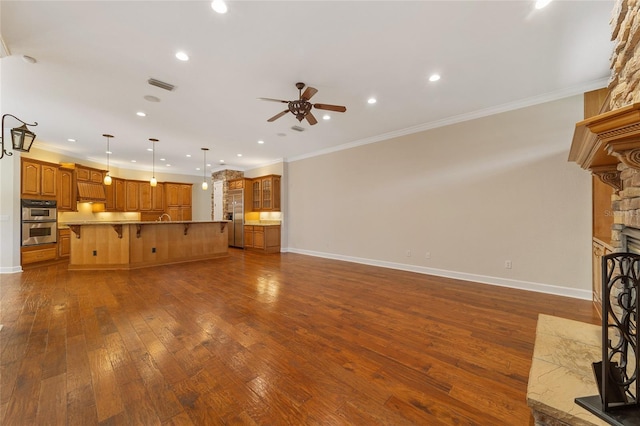 unfurnished living room featuring ceiling fan, a fireplace, crown molding, and dark hardwood / wood-style flooring