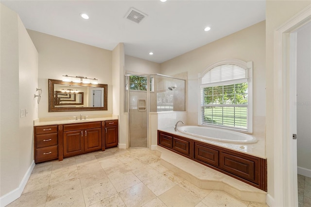 bathroom with vanity and shower with separate bathtub