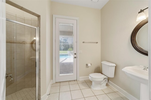 bathroom with walk in shower, tile patterned floors, and toilet