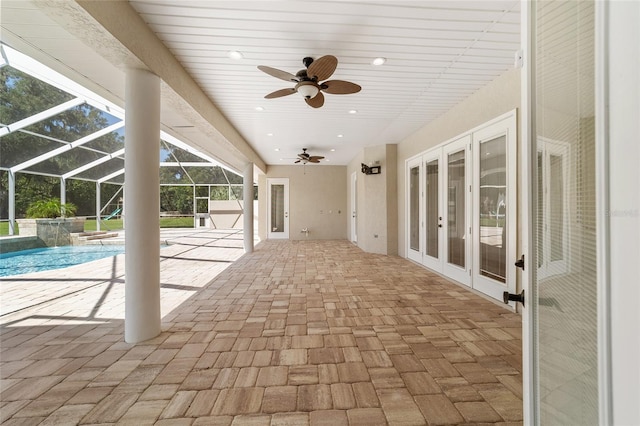 exterior space featuring a lanai, ceiling fan, french doors, and a patio area