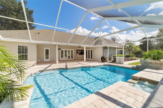 view of swimming pool featuring ceiling fan, french doors, a lanai, and a patio area